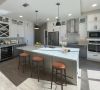 Carraway Village kitchen with large island, quartz countertops, gourmet stainless steel appliances, and custom cabinets