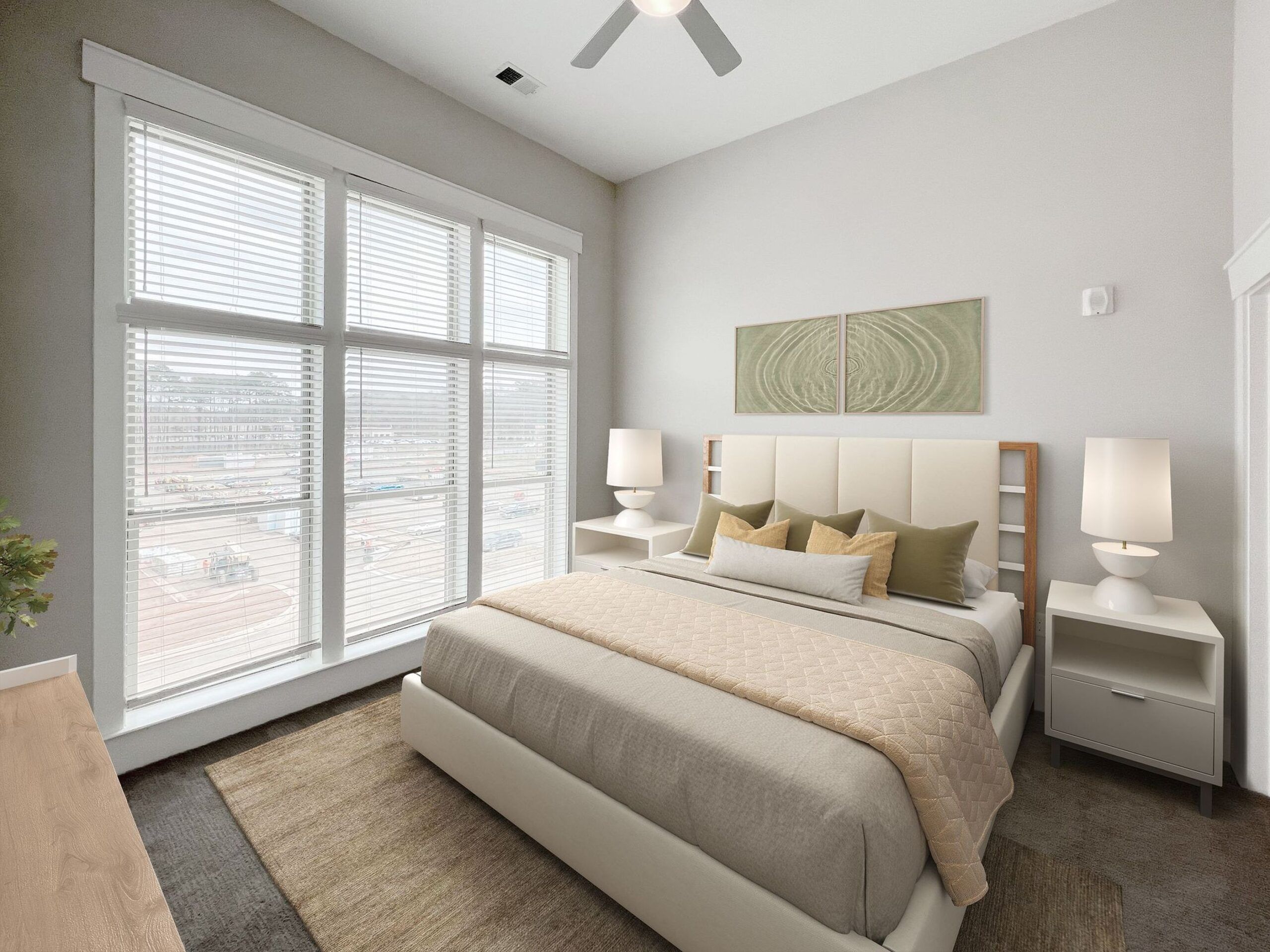 Chapel Hill apartment bedroom with large bed, ceiling fan, and floor to ceiling windows