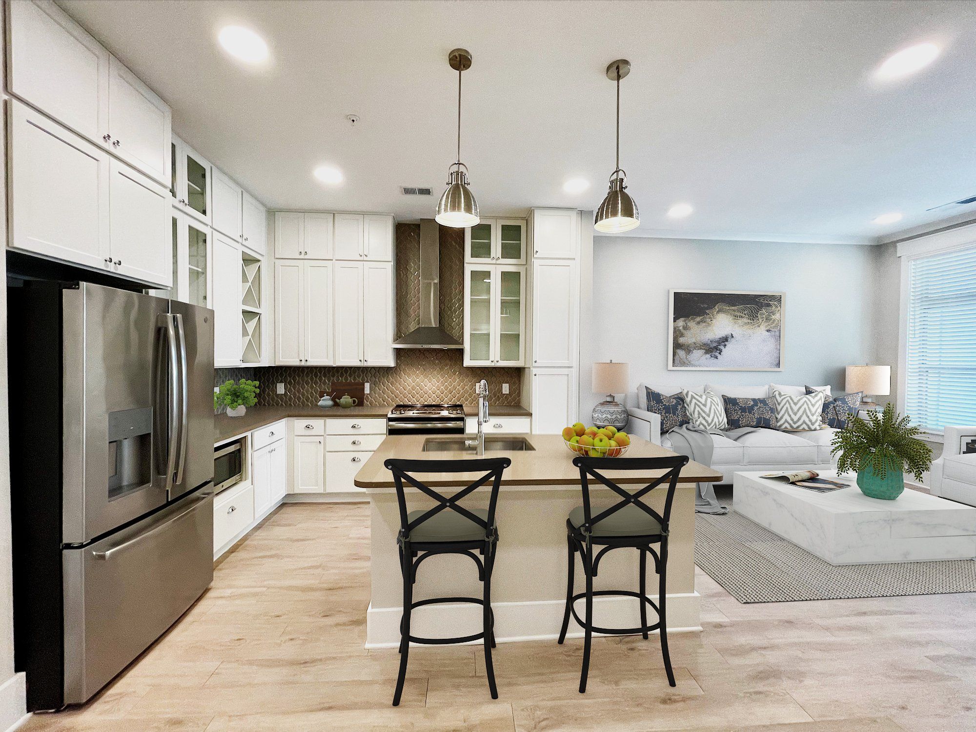 Carraway Village apartments living and dining area in one bedroom apartment with kitchen island, stainless steel appliances, and floor to ceiling cabinetry