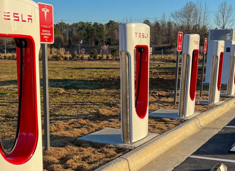 Tesla charging stations outdoors in parking lot at Carraway Village Apartments