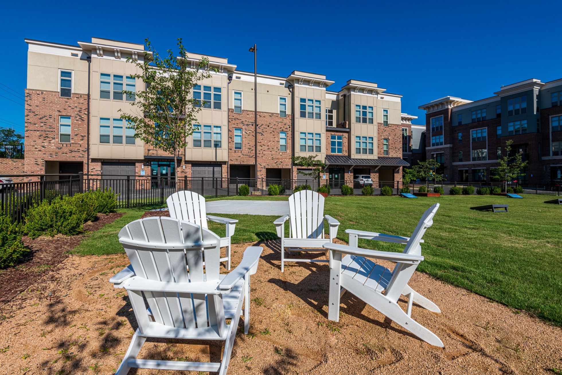 Outdoor lawn with seating outside of Carraway Village Apartments