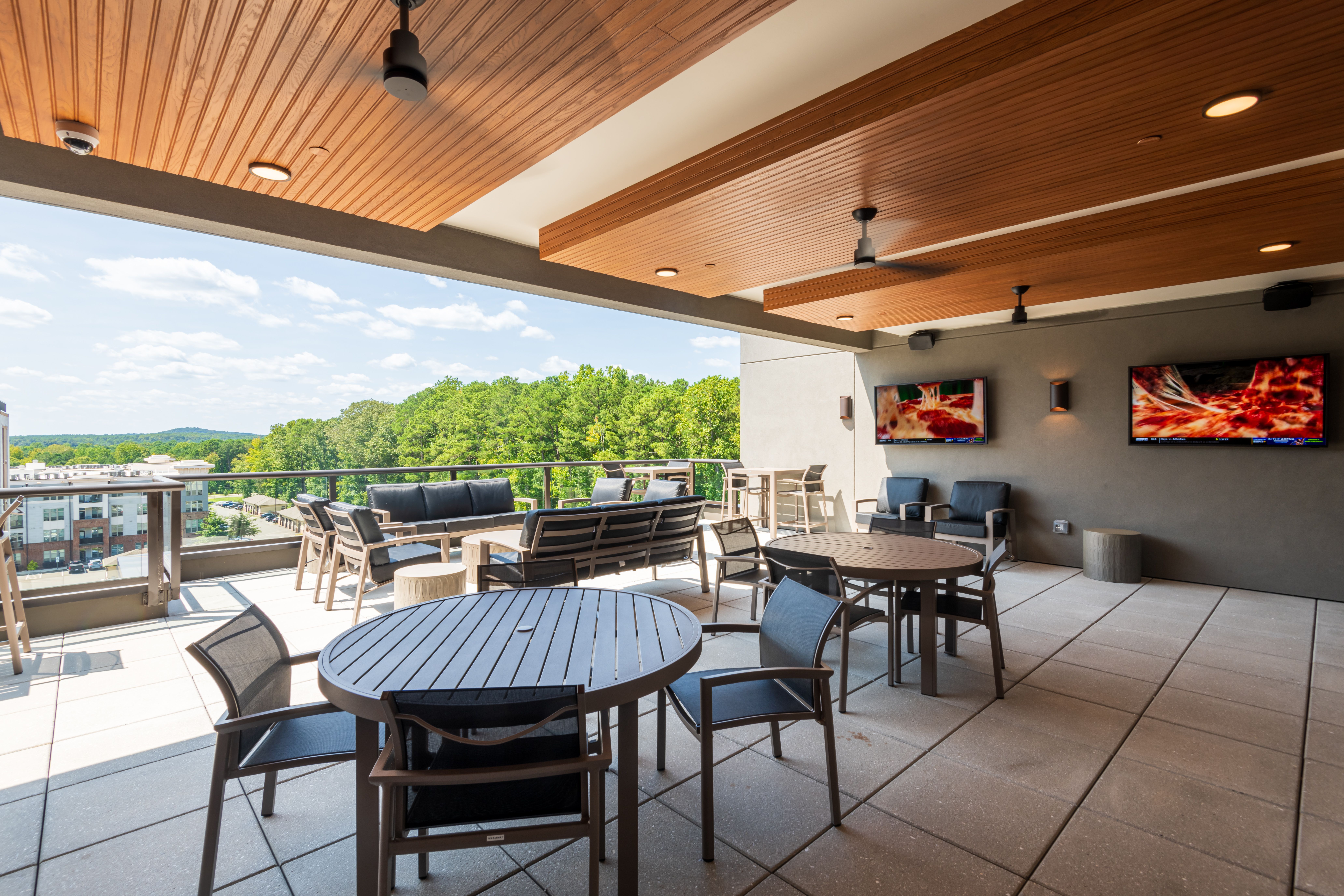 Billiards table and shuffleboard table inside game room amenity at Carraway Village Apartments in Chapel Hill, NC