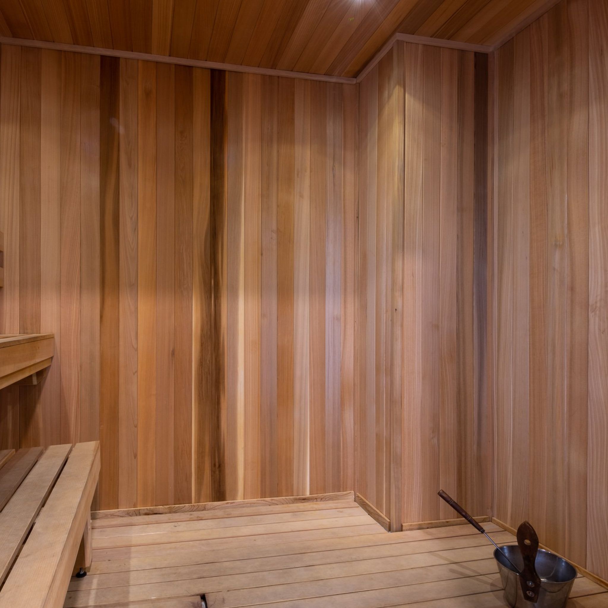 Sauna room with bench and wood flooring and walls