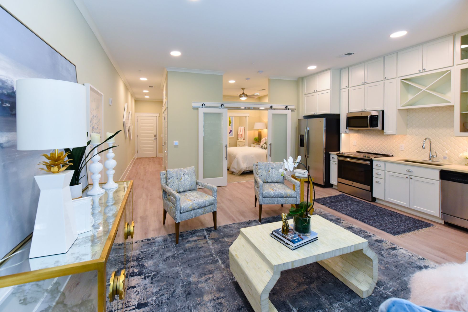 Carraway virtually staged apartment with sliding barn doors, floating kitchen island, and luxury finishes