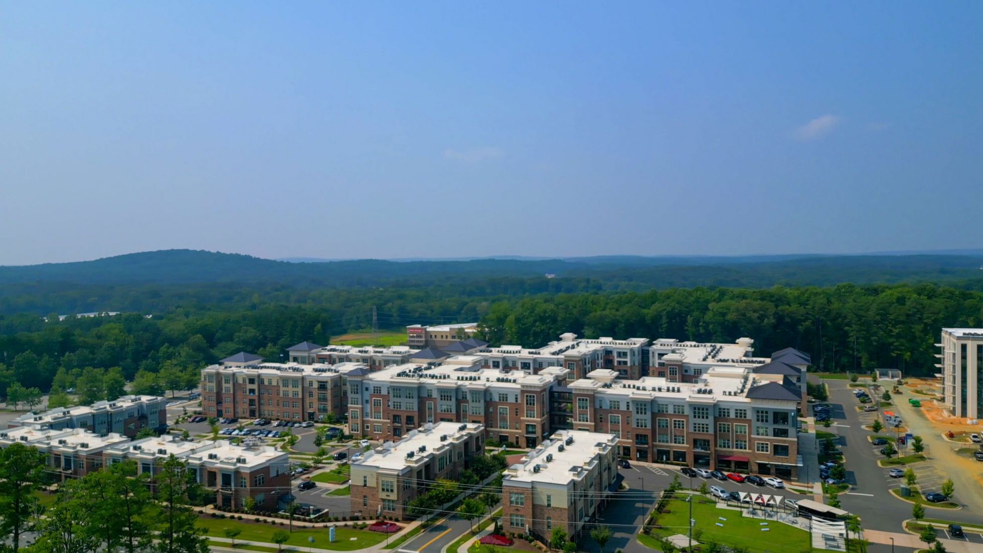 Game room with large TVs and billiards tables, apartment amenity at Carraway Village