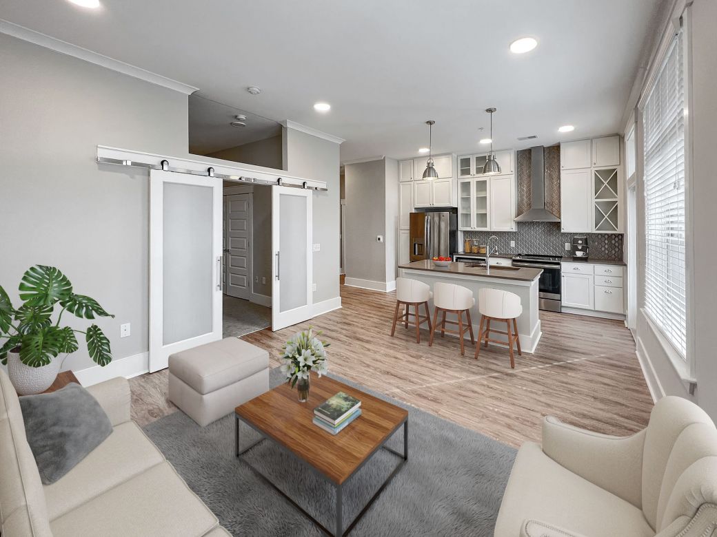 Virtual staged kitchen and living area with sliding barn doors
