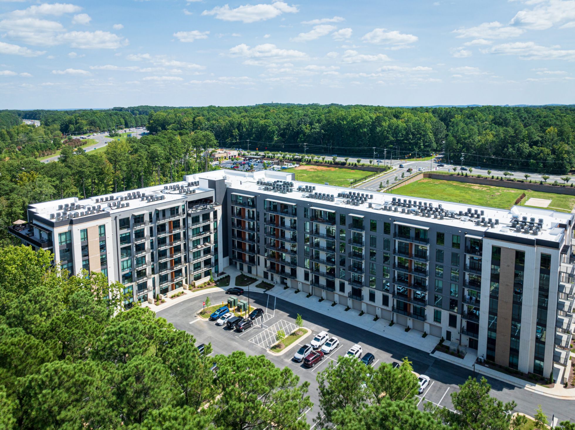 Game room with large TVs and billiards tables, apartment amenity at Carraway Village
