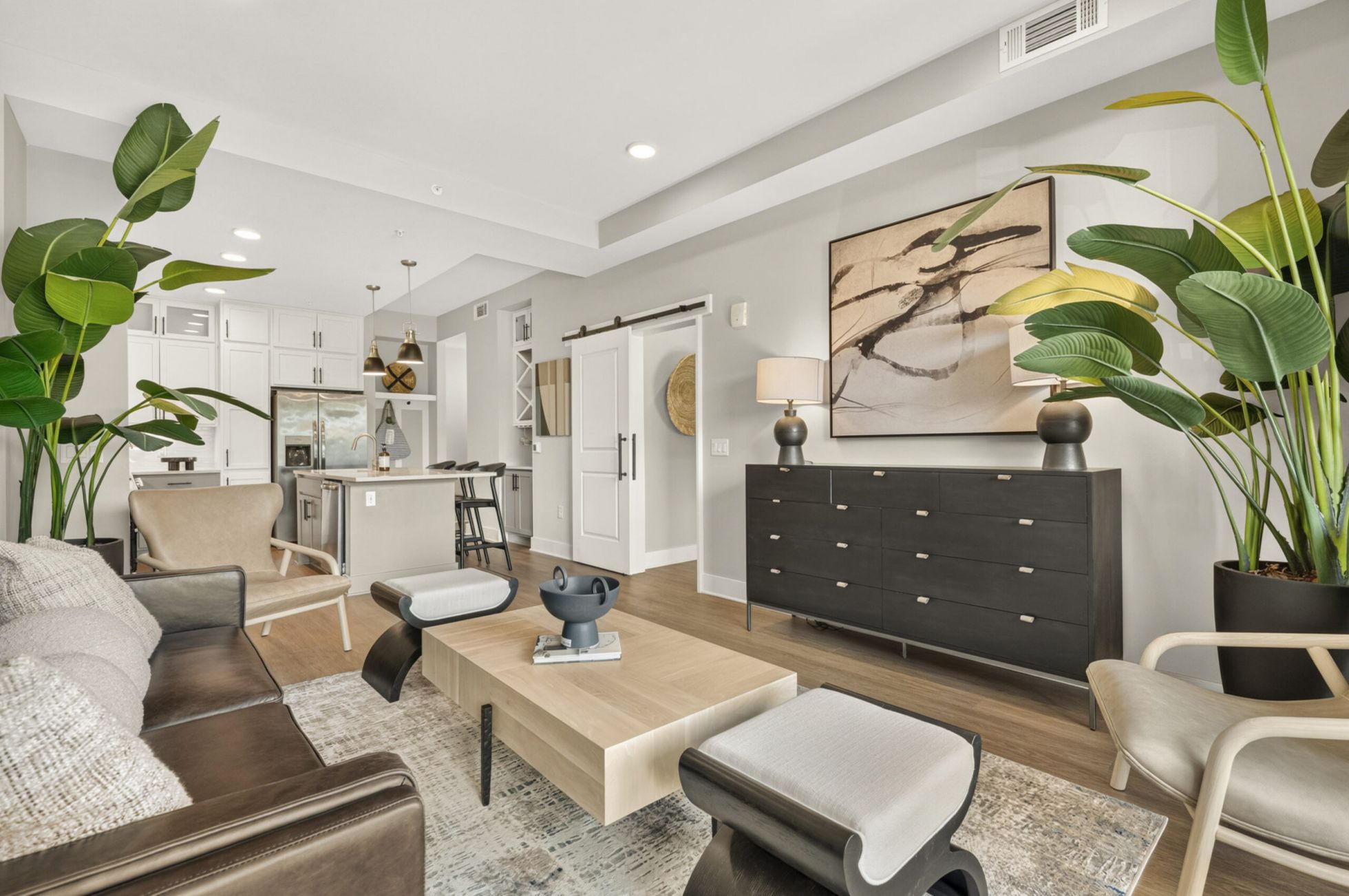 Virtually staged living and dining area with large windows, luxury hard-wood flooring, and high-end finishes