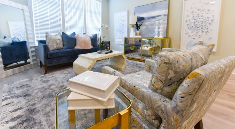 Living room area of apartment with a couch, chair, and coffee table