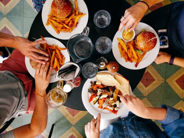 People dining together, table with food dishes
