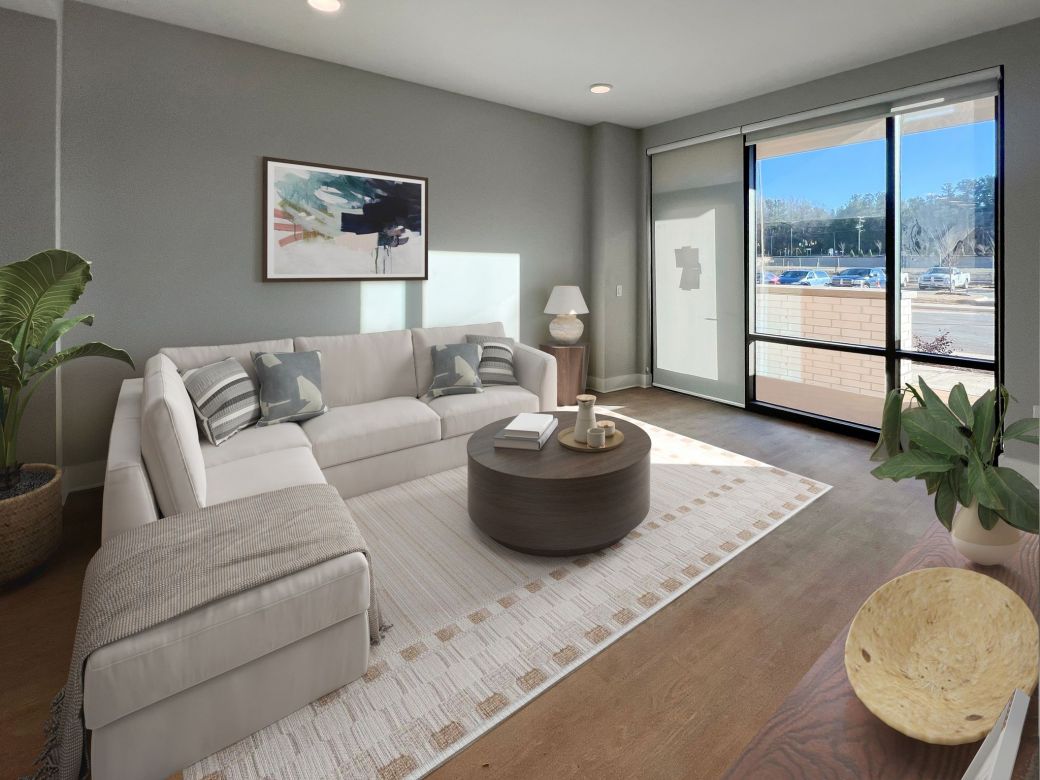 Carraway Village living area with large windows, patio access, and modern furnishings