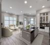 Beautiful apartment living and dining area with large windows, large kitchen island, and stainless steel appliances