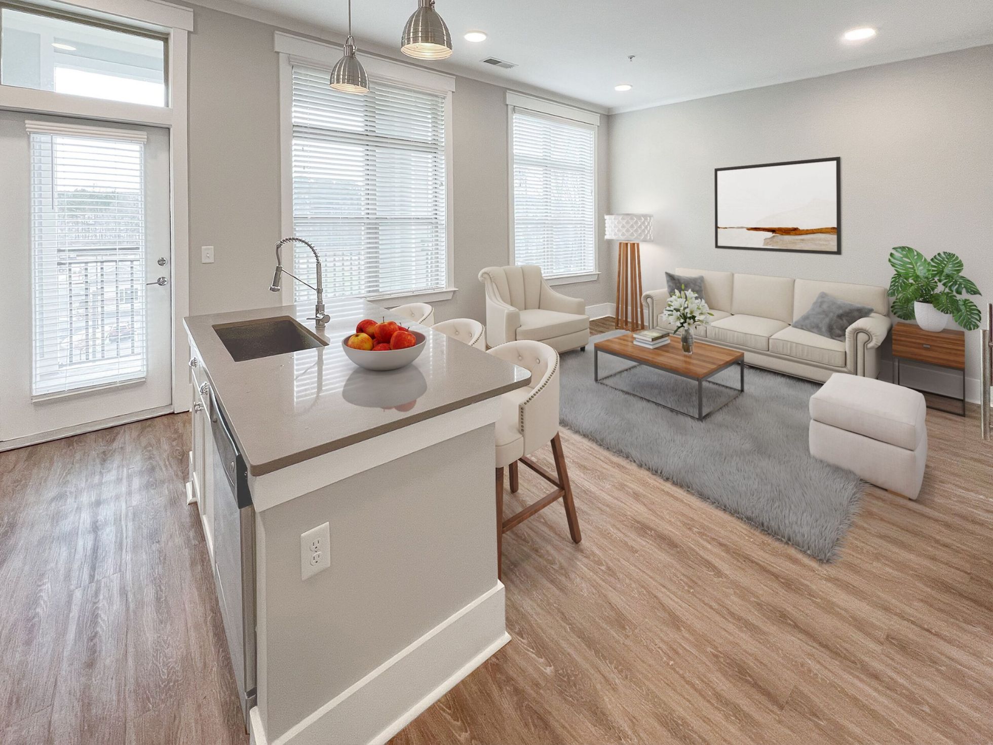 Luxury Chapel Hill apartment living room with large couch, two chairs, and floor to ceiling windows